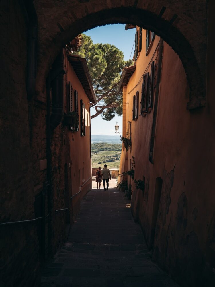 people walking down a narrow street